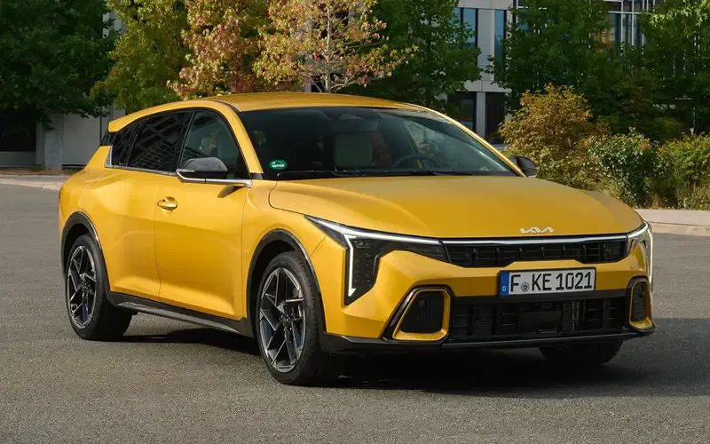 Kia K4 Hatch front three-quarter view in yellow