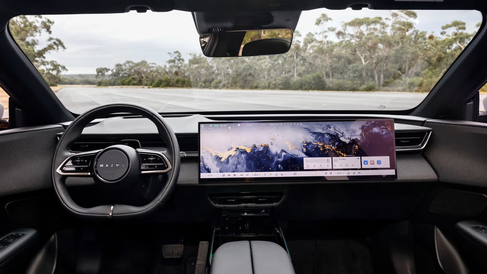 Mazda CX-6e interior showing massive widescreen display spanning the full dashboard width