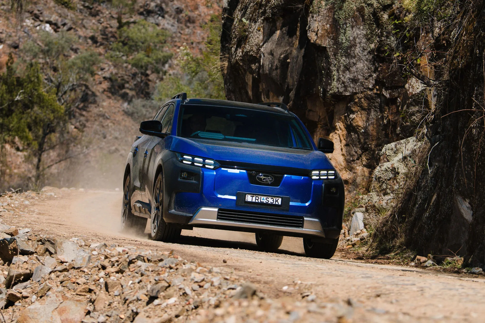 Subaru Trailseeker driving down a rocky dirt road