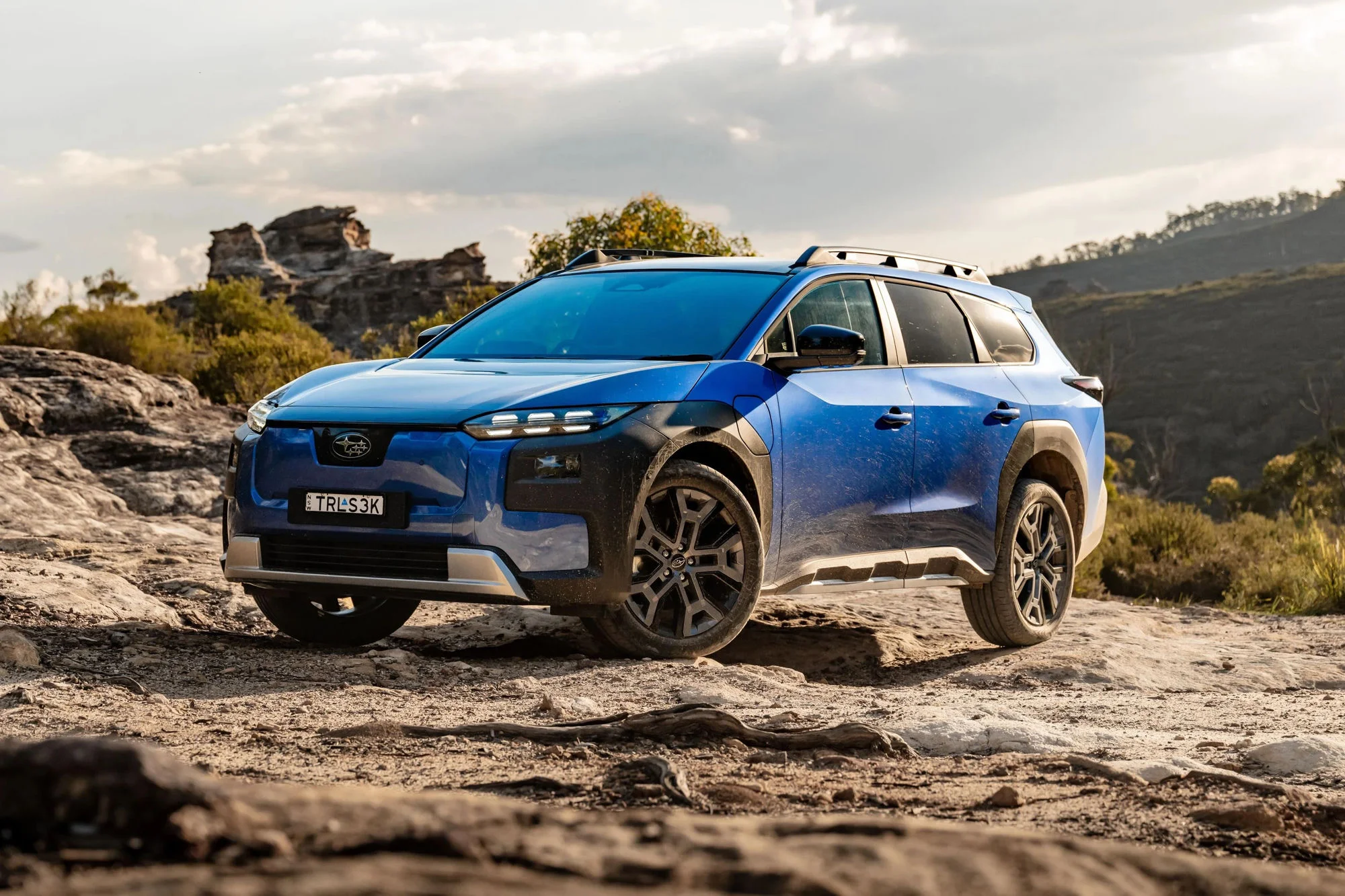 2026 Subaru Trailseeker front three-quarter on rocky terrain in Blue Pearl