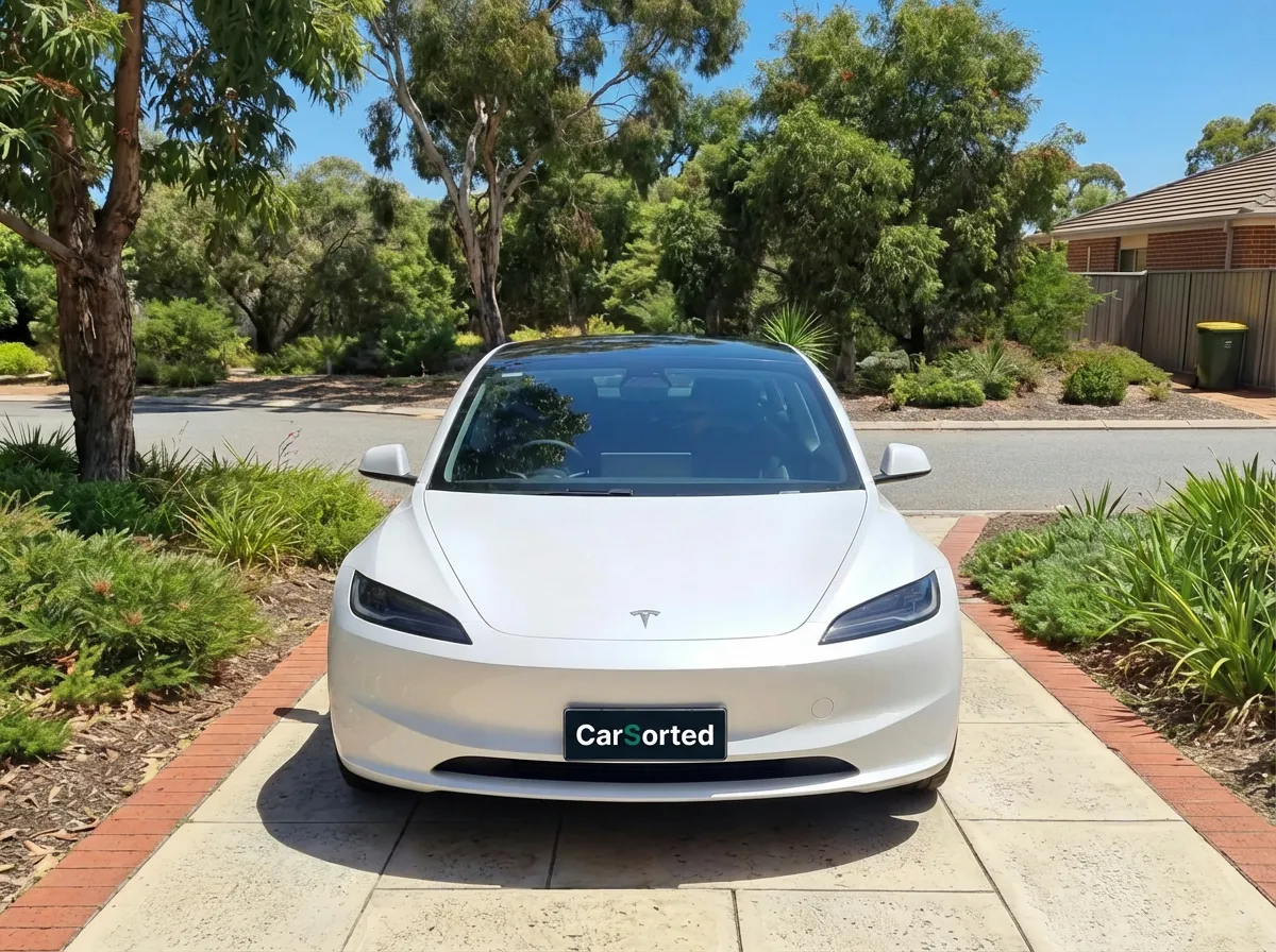 Tesla Model 3 Highland Standard Range RWD in Ultra Red, front three-quarter view